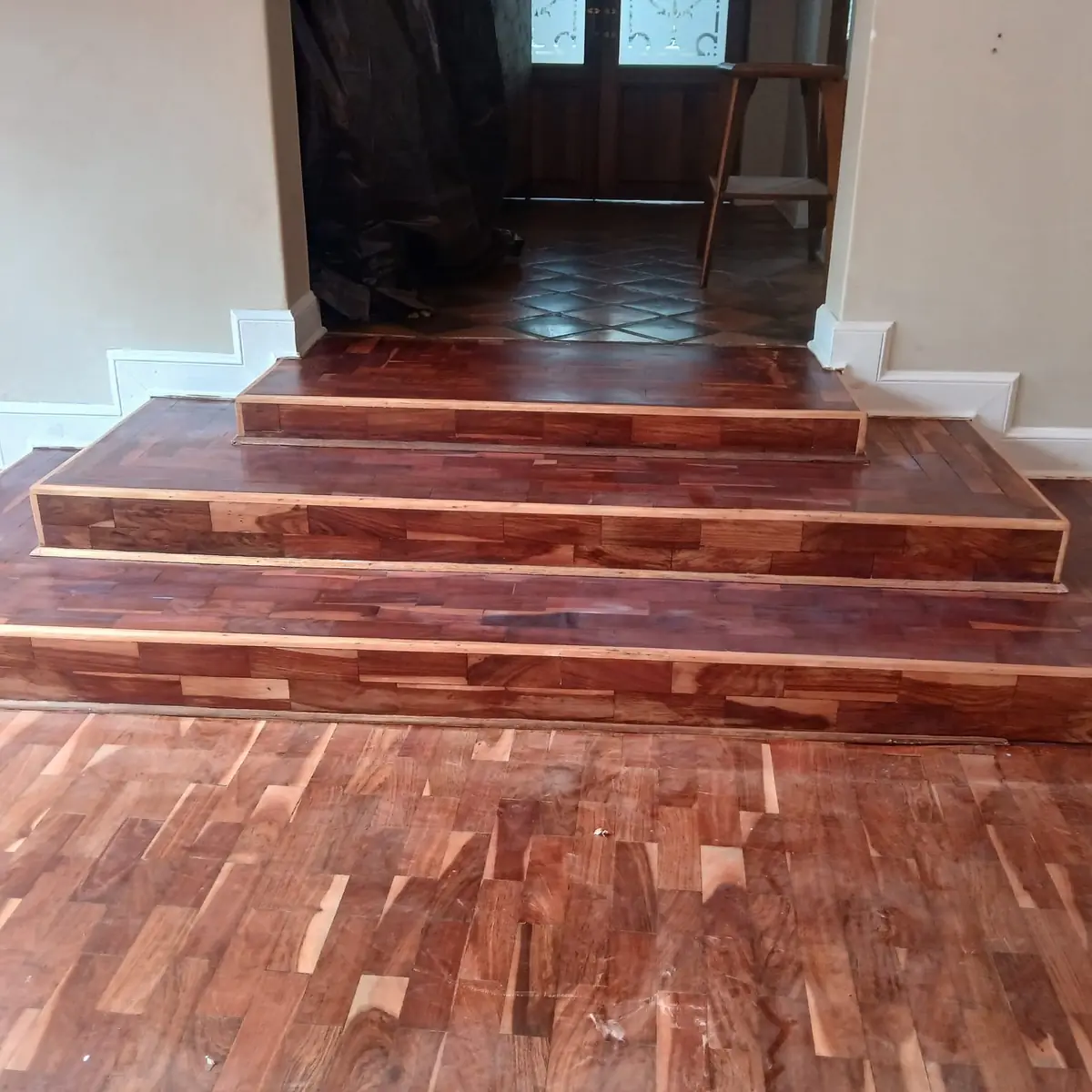 Hardwood strip flooring across a split-level living area in Midrand, installed by Impi Teak