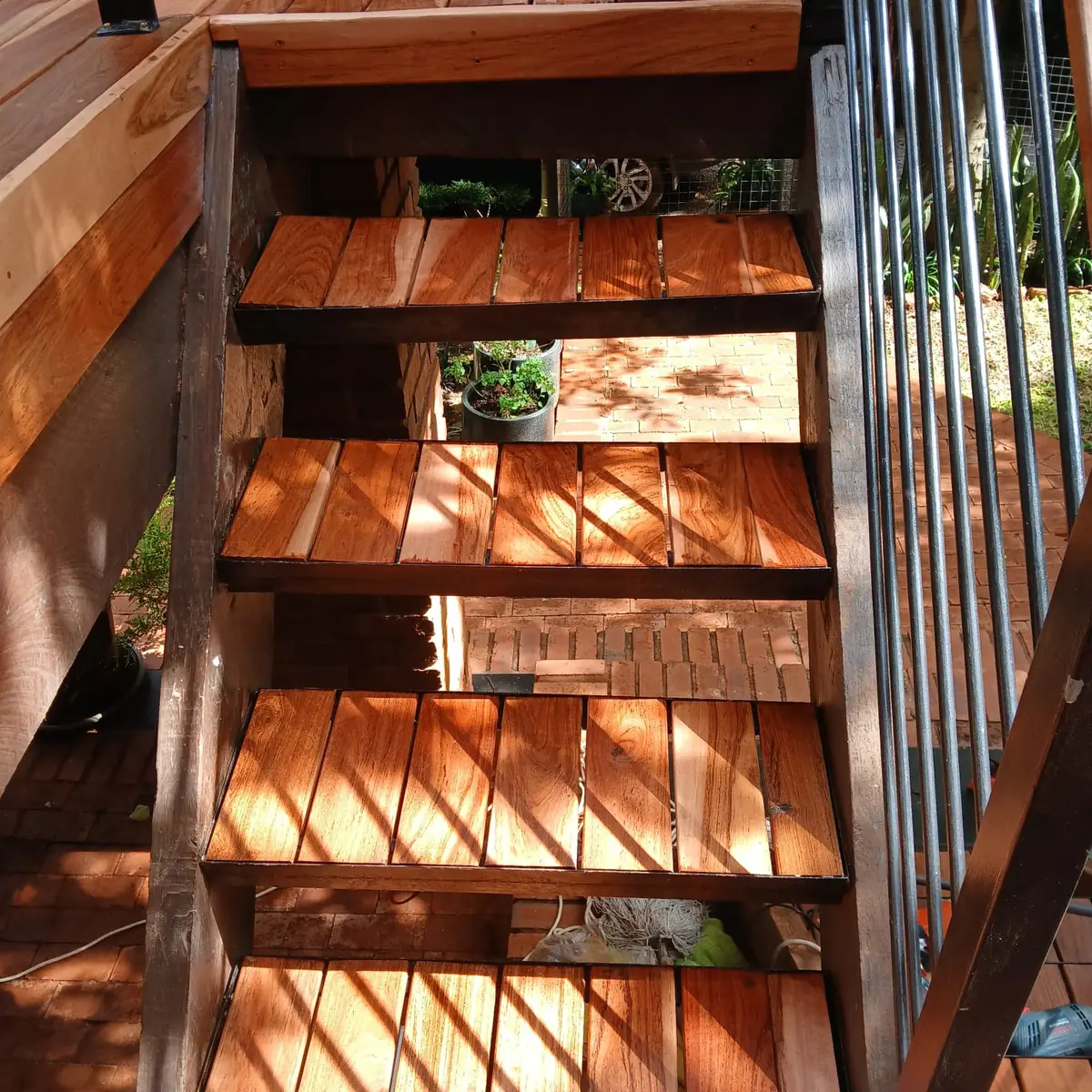 Open-riser hardwood staircase with steel stringers in Midrand built by Impi Teak