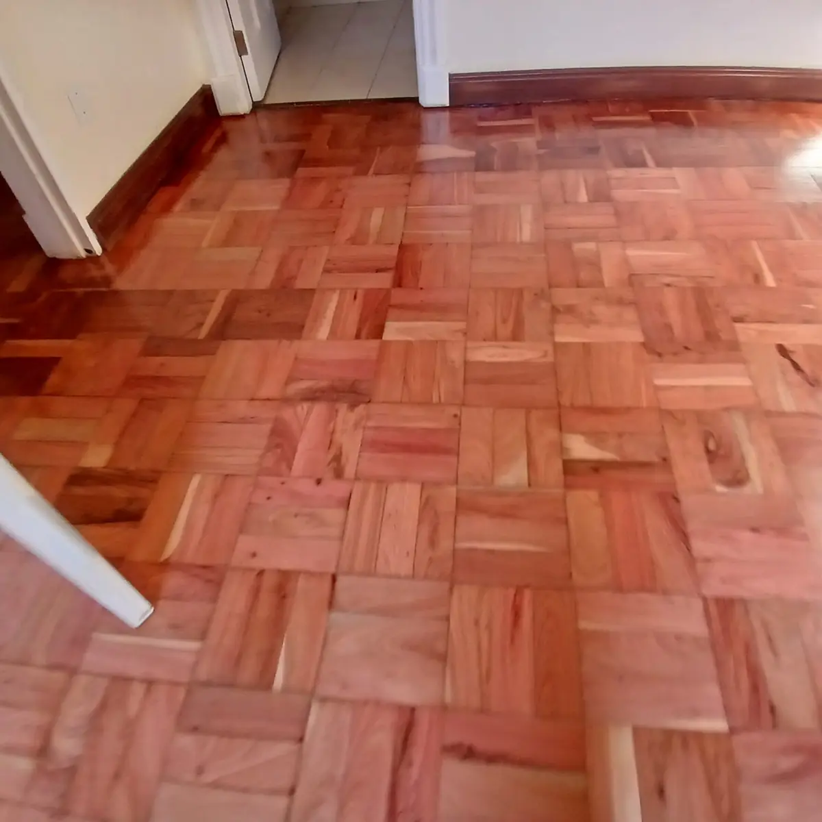 Restored mosaic parquet wooden flooring in a Johannesburg living room by Impi Teak