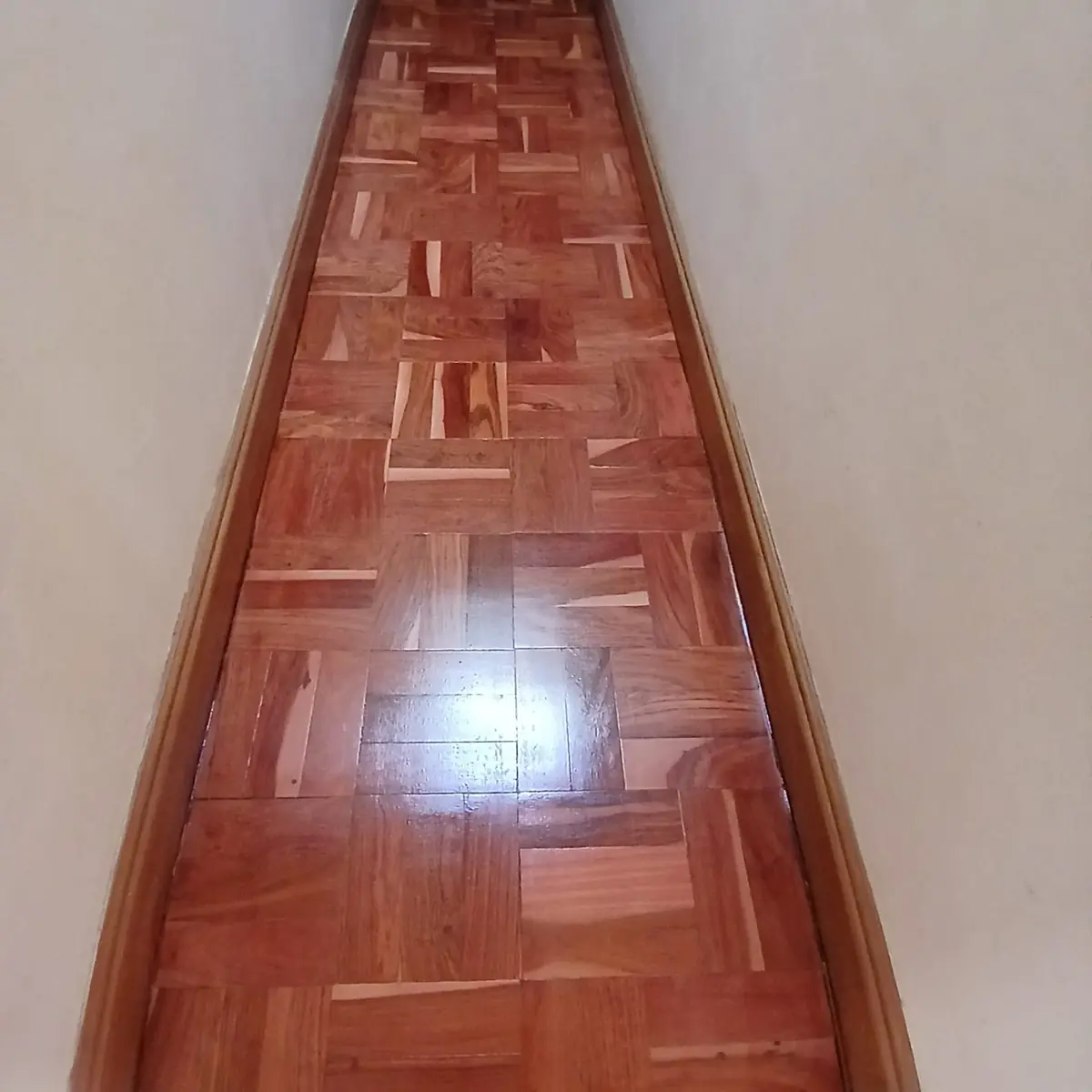 Parquet flooring laid through a Centurion passage and restored by Impi Teak
