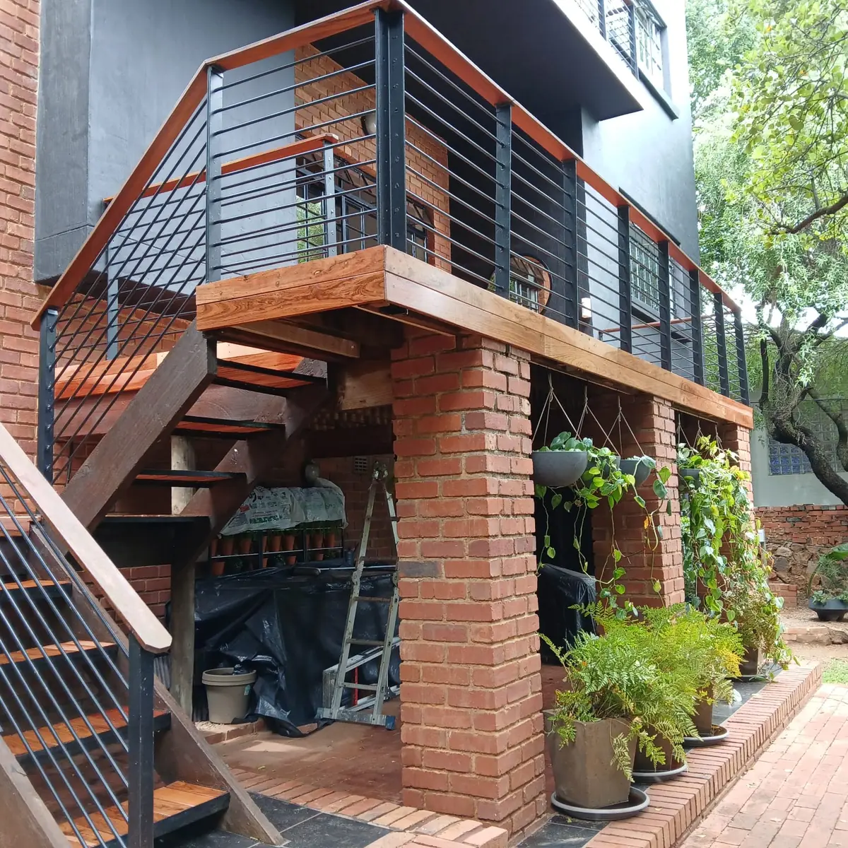 Raised hardwood deck with a timber staircase down to the garden in Midrand