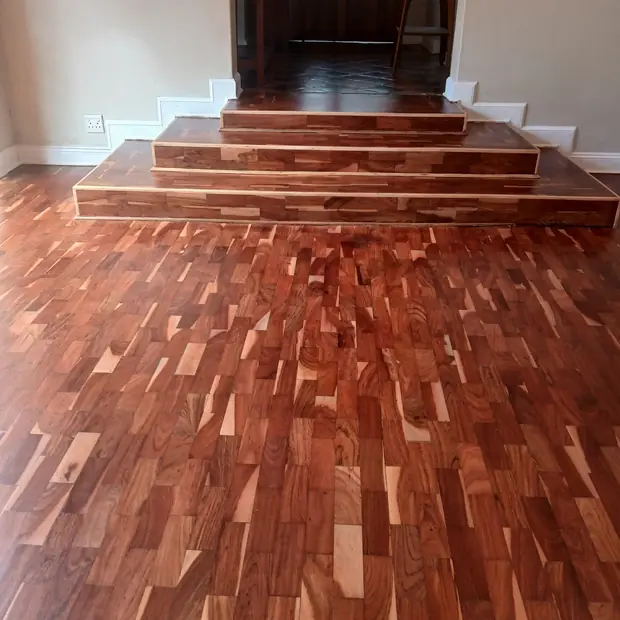 Solid hardwood strip flooring with matching timber steps installed by Impi Teak in Gauteng