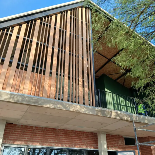 Angled timber slat screening fitted to a building exterior in Gauteng by Impi Teak