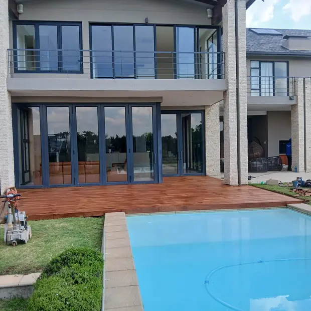Balau wooden pool deck wrapping a Fourways swimming pool, built by Impi Teak deck builders