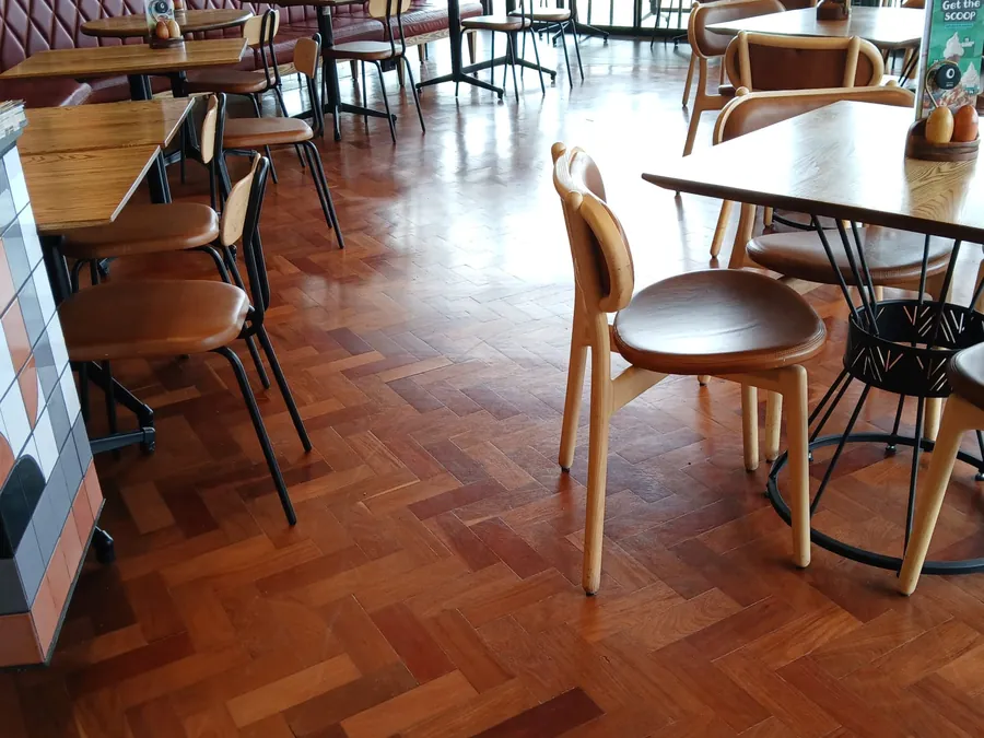 Parquet flooring in a busy restaurant interior installed by Impi Teak