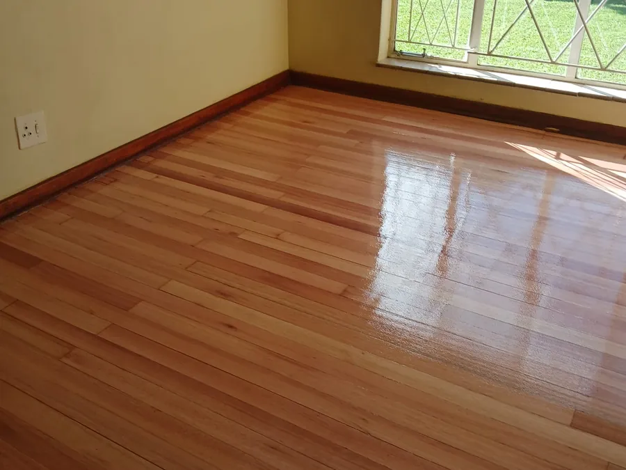Sealed solid hardwood flooring running to the skirting in a Gauteng home